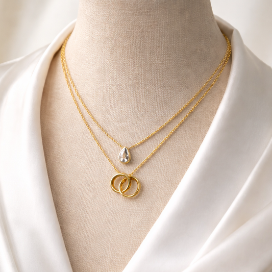 Dual Layered Necklace with Teardrop Stone & Interlocking Rings Pendant – Adjustable Chain | Imitation Gold