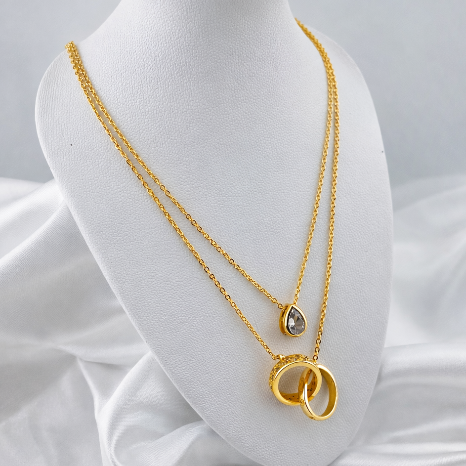 Dual Layered Necklace with Teardrop Stone & Interlocking Rings Pendant – Adjustable Chain | Imitation Gold