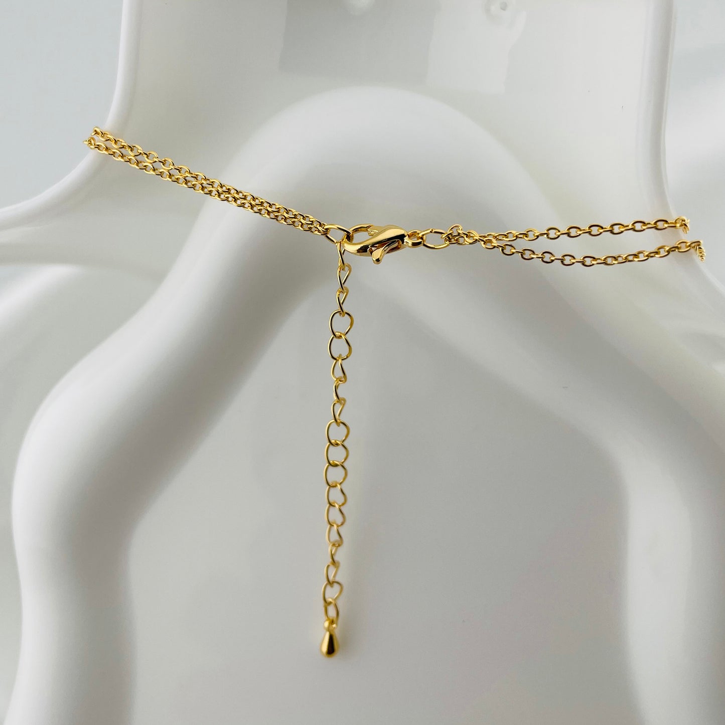 Dual Layered Necklace with Teardrop Stone & Interlocking Rings Pendant – Adjustable Chain | Imitation Gold